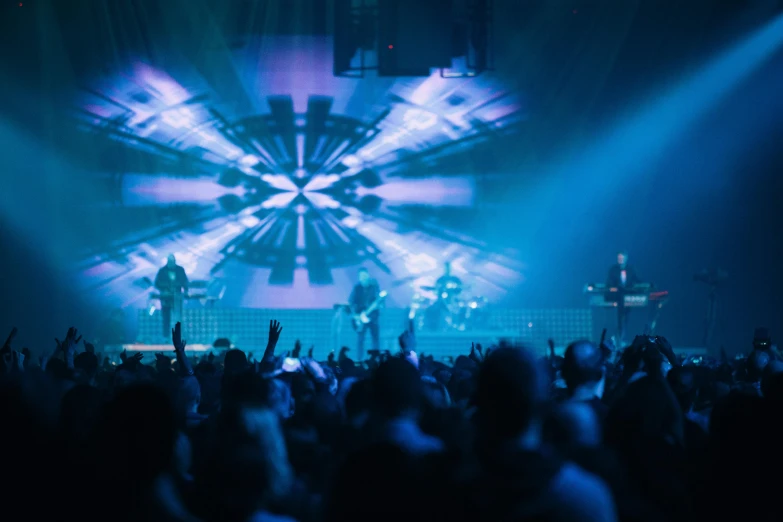 a group of people standing on top of a stage, bursting with blue light, gigachad jesus, perfect circle, blur: -5