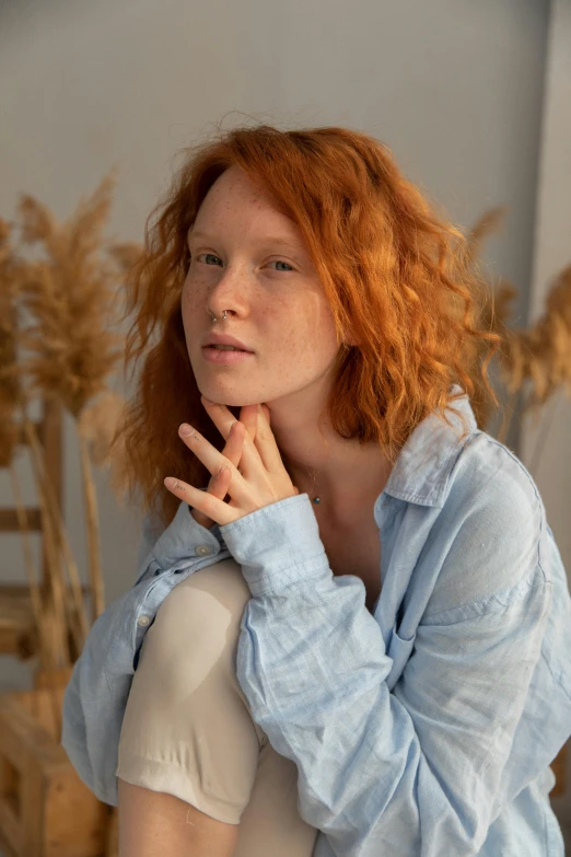 a woman with red hair posing for a picture, an album cover, trending on pexels, wearing a linen shirt, thoughtful ), high quality photo, nadezhda tikhomirova