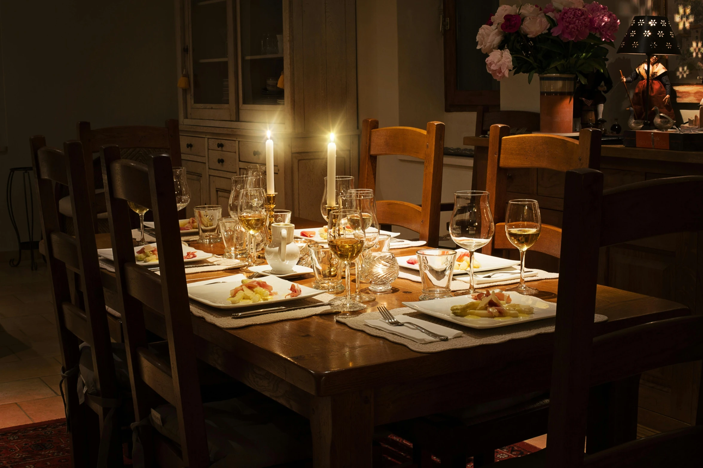 a table that has a bunch of plates on it, by Carey Morris, pexels contest winner, renaissance, evening, dining table, family friendly, romantic light