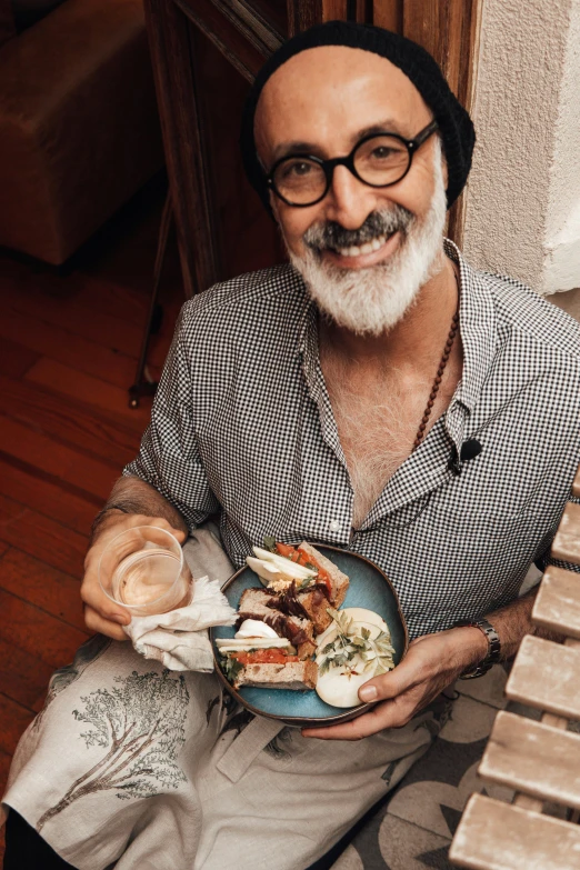 a man sitting at a table with a plate of food, a portrait, pexels contest winner, hipster dad, 5 5 yo, australian, bao pnan