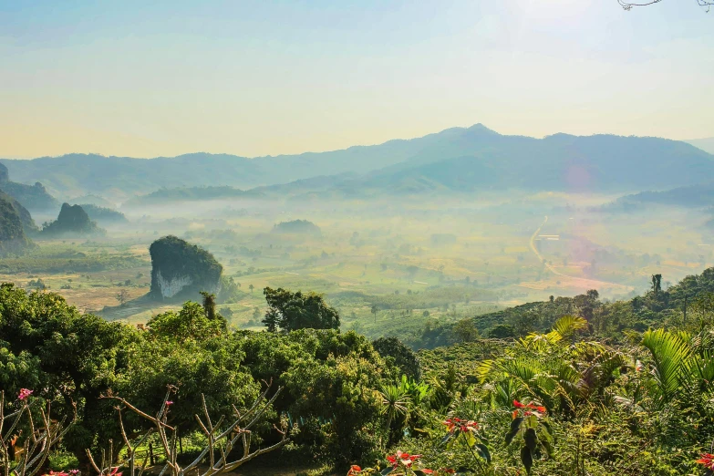 a view of a valley with mountains in the distance, pexels contest winner, sumatraism, himeji rivendell garden of eden, nivanh chanthara, youtube thumbnail, slightly sunny weather