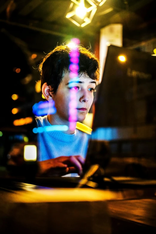a young man sitting in front of a laptop computer, by Adam Marczyński, happening, bright lights, portrait of 1 5 - year - old boy, creative coding, looking serious