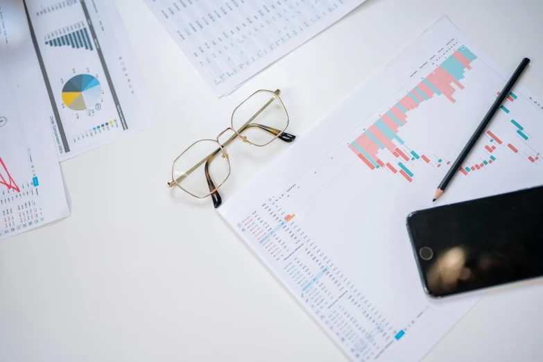 a cell phone sitting on top of a desk next to a pair of glasses, a picture, trending on pexels, analytical art, graphs, trading stocks, 🦩🪐🐞👩🏻🦳, reference sheet white background