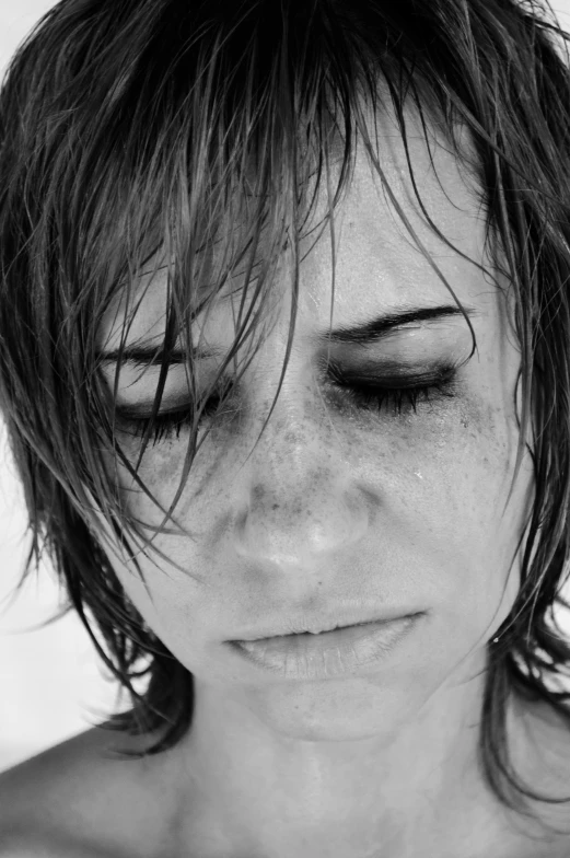 a black and white photo of a woman with wet hair, a black and white photo, pexels, hyperrealism, with a bruised face and bruises, people crying, photo of a woman, uploaded