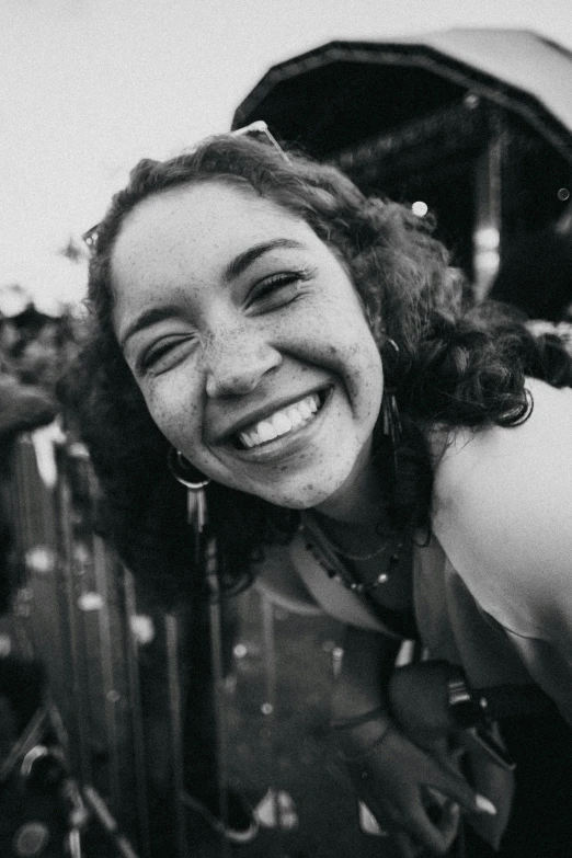 a black and white photo of a woman smiling, pexels contest winner, a person at a music festival, ariel perez, dimples, in her early 20s