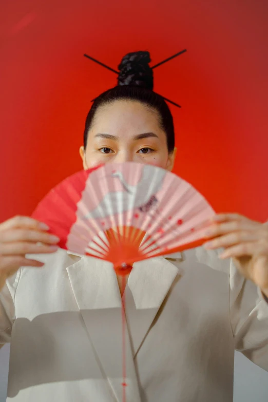 a woman holding a fan in front of her face, an album cover, inspired by Fan Qi, pexels contest winner, sumo japanese, only with red, kano), still from a music video