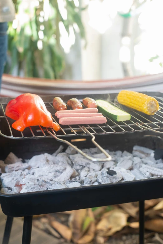 a close up of a grill with food on it, bowl filled with food, sausages, barbecuing chewing gum, pepper