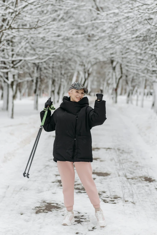 a woman that is standing in the snow with skis, inspired by Louisa Matthíasdóttir, pexels contest winner, in a city park, doing a sassy pose, black, 🎀 🗡 🍓 🧚