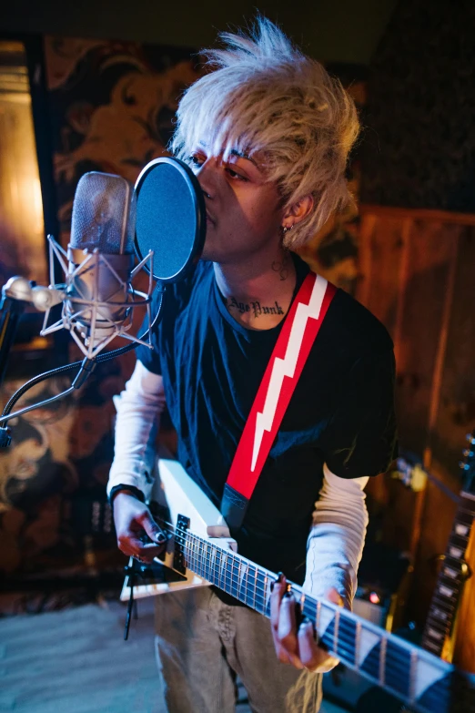 a man that is playing a guitar in a room, private press, short platinum hair tomboy, promo image, emo, holding microphone