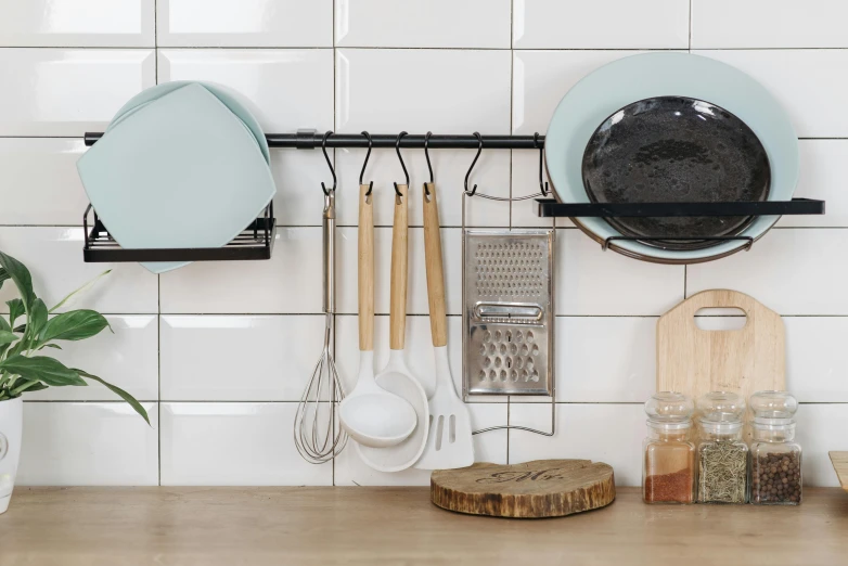 a wooden counter topped with pots and pans, inspired by Peter de Sève, unsplash, minimalism, black and cyan color scheme, rack, pastel blue, panoramic shot