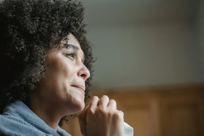 a woman sitting in a chair with her hand on her chin, pexels, hurufiyya, flowing mucus, praying, mixed-race woman, thumbnail