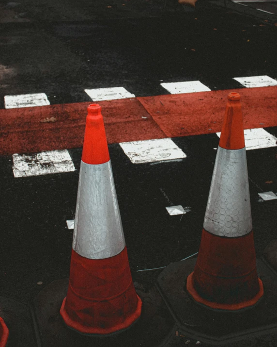 a group of traffic cones sitting on the side of a road, an album cover, trending on unsplash, constructivism, cross hatched, gay rights, red white black colors, vlc screenshot