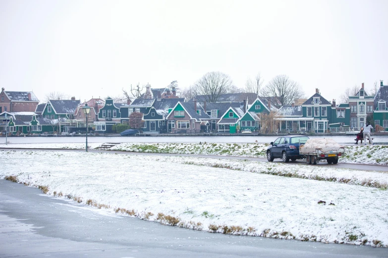 a truck that is sitting in the snow, by Jan Tengnagel, happening, dutch houses along a river, 2022 photograph, bright castleton green, high quality image