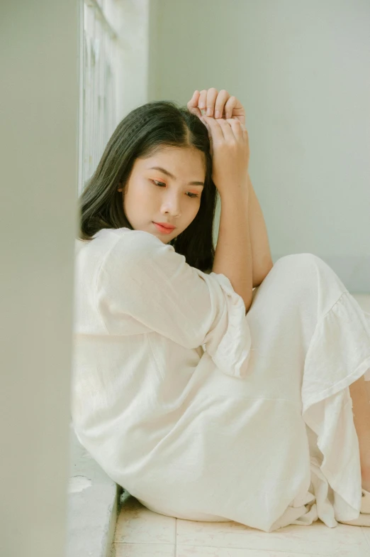 a woman in a white dress sitting on the floor, by Tan Ting-pho, trending on pexels, cream colored peasant shirt, korean woman, sleepwear, thoughtful )