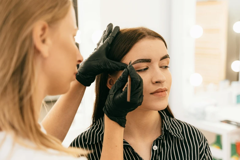 a woman getting her eyebrows done at a salon, by Nicolette Macnamara, trending on pexels, flat colour, thumbnail, full body image, te pae