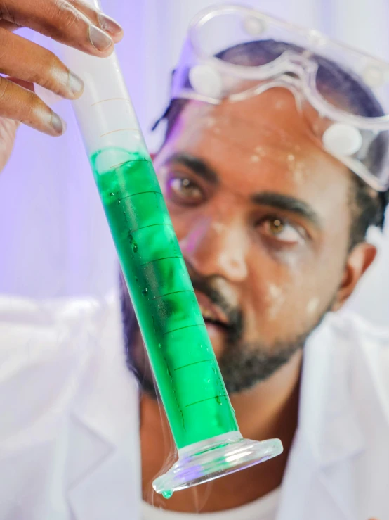 a man in a lab coat holding a green liquid, pexels contest winner, dr zeus, avatar image, tall shot, making of