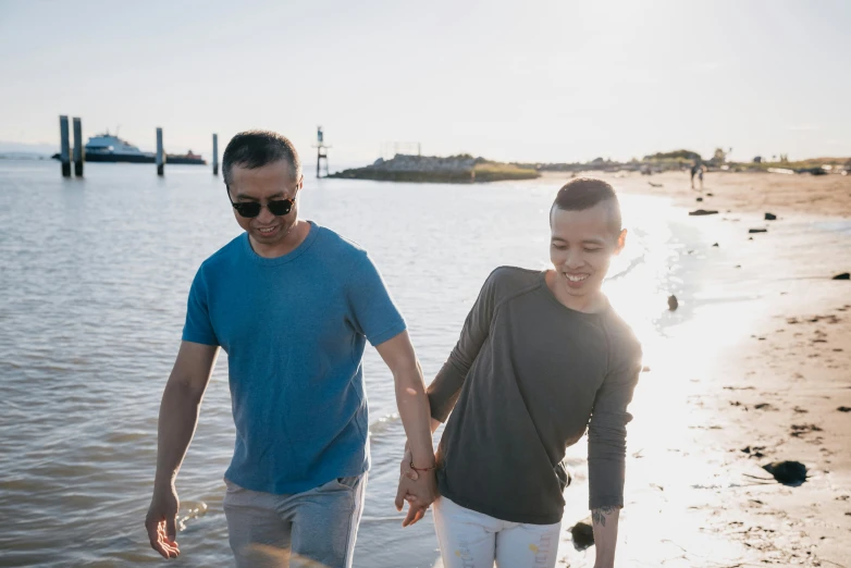 a man and a boy walking on a beach, unsplash, happening, asian female, non-binary, smiling couple, youtube thumbnail