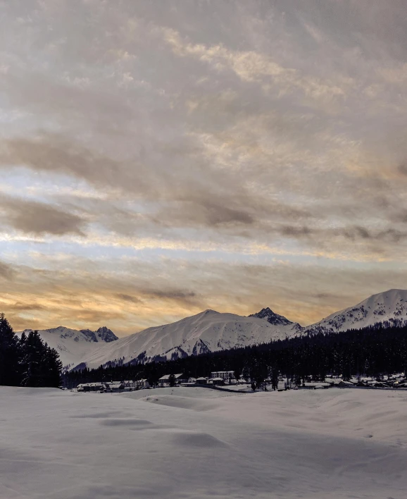 a man riding skis down a snow covered slope, by Sebastian Spreng, pexels contest winner, hurufiyya, sunset panorama, grey, panorama view of the sky, today\'s featured photograph 4k