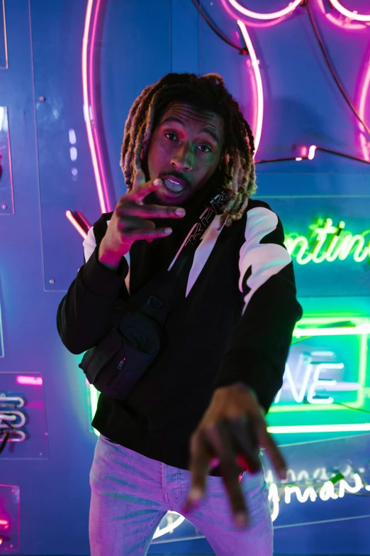 a man with dreadlocks standing in front of a neon sign, trending on pexels, reflective puffer jacket, lil uzi vert, gaming, very very low quality picture