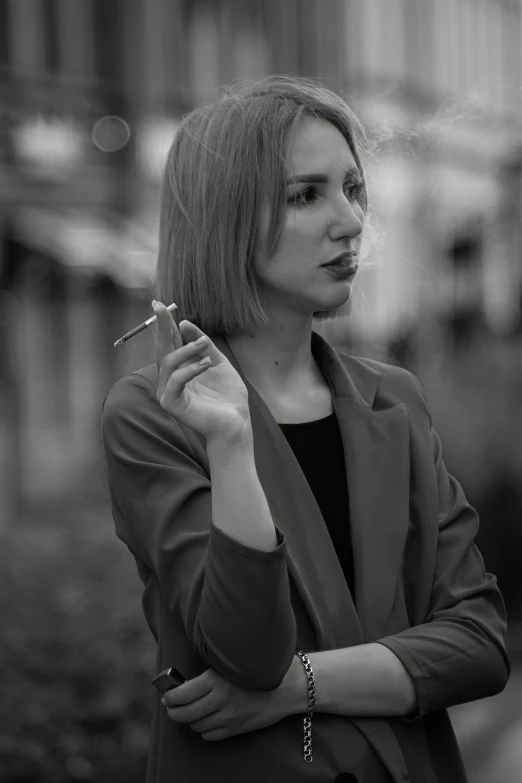 a black and white photo of a woman smoking a cigarette, a black and white photo, inspired by August Sander, pexels contest winner, aestheticism, фото девушка курит, wearing a blazer, a blond, amouranth