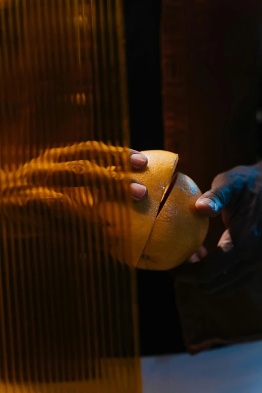 a close up of a person peeling an orange, by Jan Tengnagel, symbolism, still from alita, harp, translucent sphere, in thick layers of rhythms