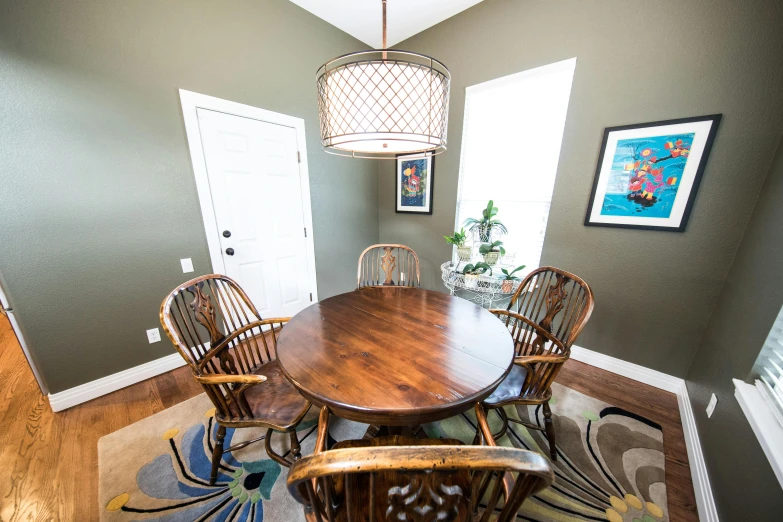 a dining room with a wooden table and chairs, by Josh Bayer, fisheye 4, fan favorite, wood furnishings, backrooms office space