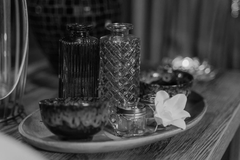 a plate with salt and pepper shakers on it, a black and white photo, pexels, renaissance, glass flowers, spa, high details photo, bottles