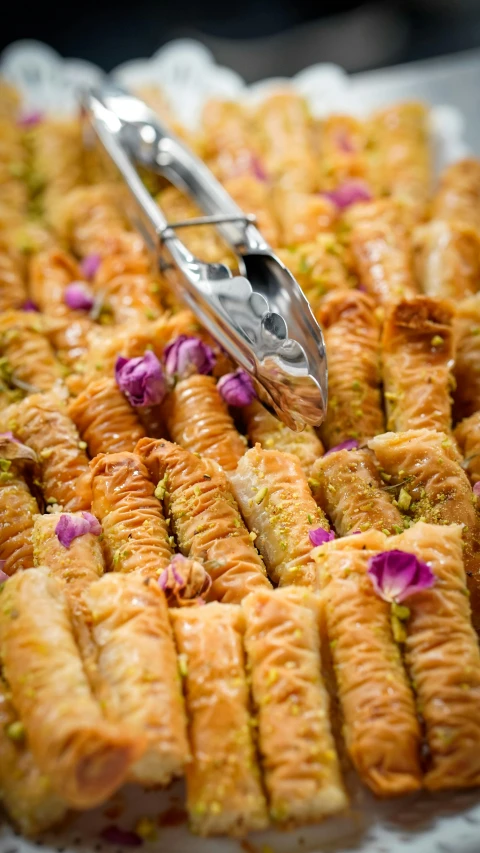 a close up of a tray of food on a table, hurufiyya, pastry, no cropping, slide show, purple