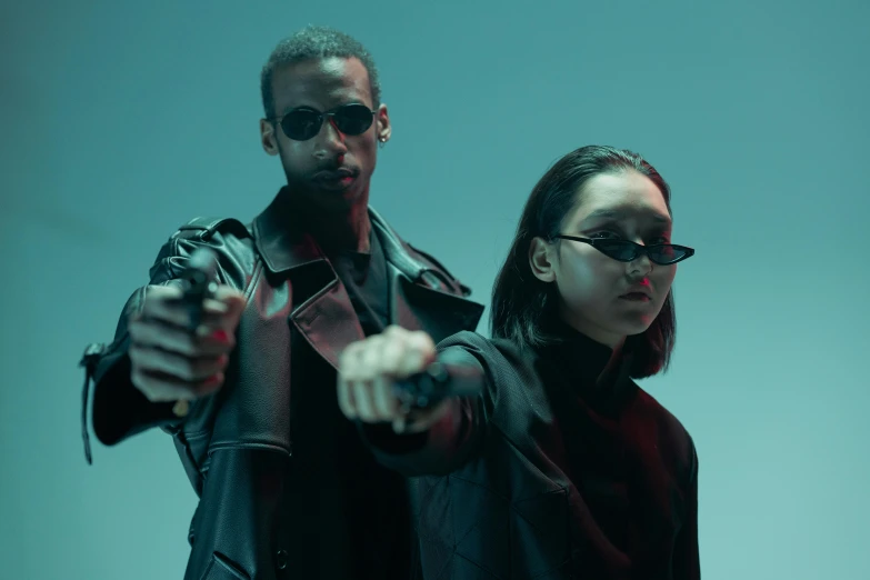 a couple of people standing next to each other, trending on pexels, bauhaus, holding a futuristic gun, cyberpunk sunglasses, cop, a teen black cyborg