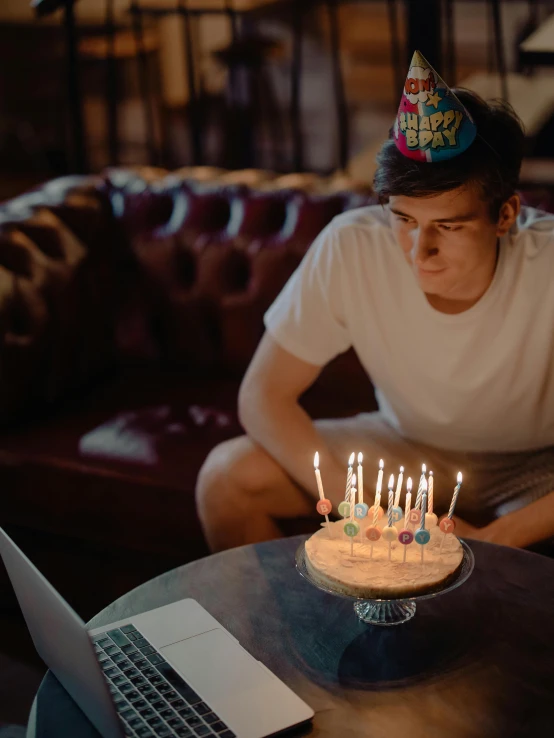 a man sitting at a table with a birthday cake in front of him, pexels contest winner, happening, 1 9 year old, gif, bisexual lighting, ( ( theatrical ) )