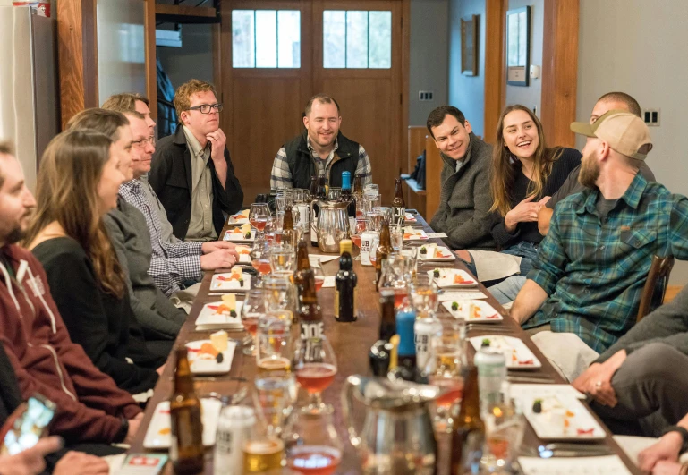 a group of people sitting around a long table, skye meaker, craig mulins, thumbnail, a cozy