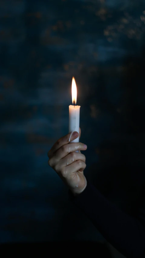 a person holding a lit candle in their hand, an album cover, inspired by Elsa Bleda, pexels, paul barson, 15081959 21121991 01012000 4k, mourning, getty images