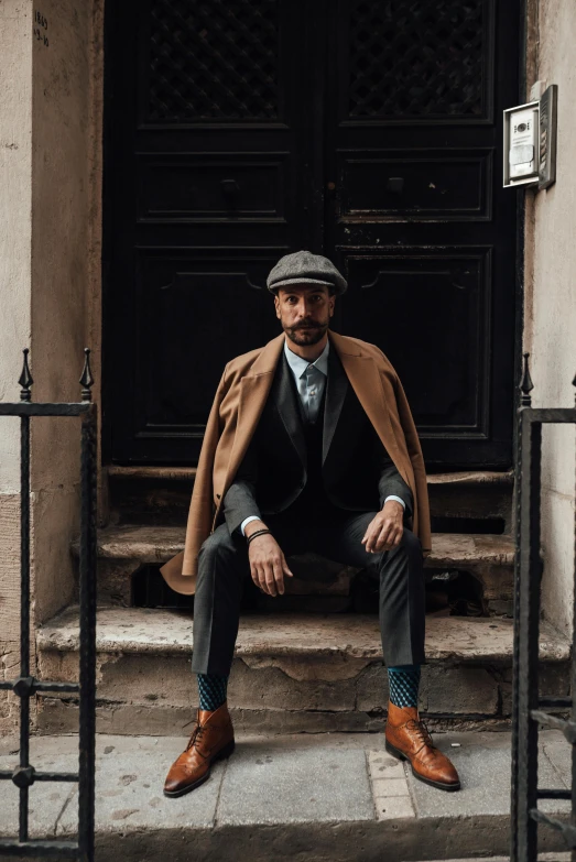 a man sitting on the steps of a building, costumes from peaky blinders, thumbnail, streetwear, benoit b