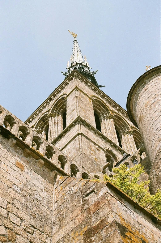 a tall tower with a clock on top of it, inspired by Pierre Toutain-Dorbec, unsplash, romanesque, flying buttresses, close-up from above, normandy, taken in the mid 2000s