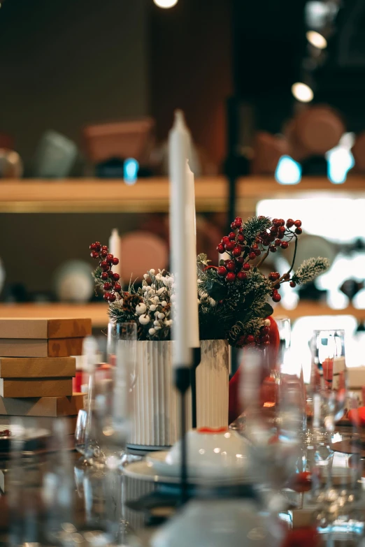 a close up of a table with a candle on it, glassware, presents, zoomed in, from the distance