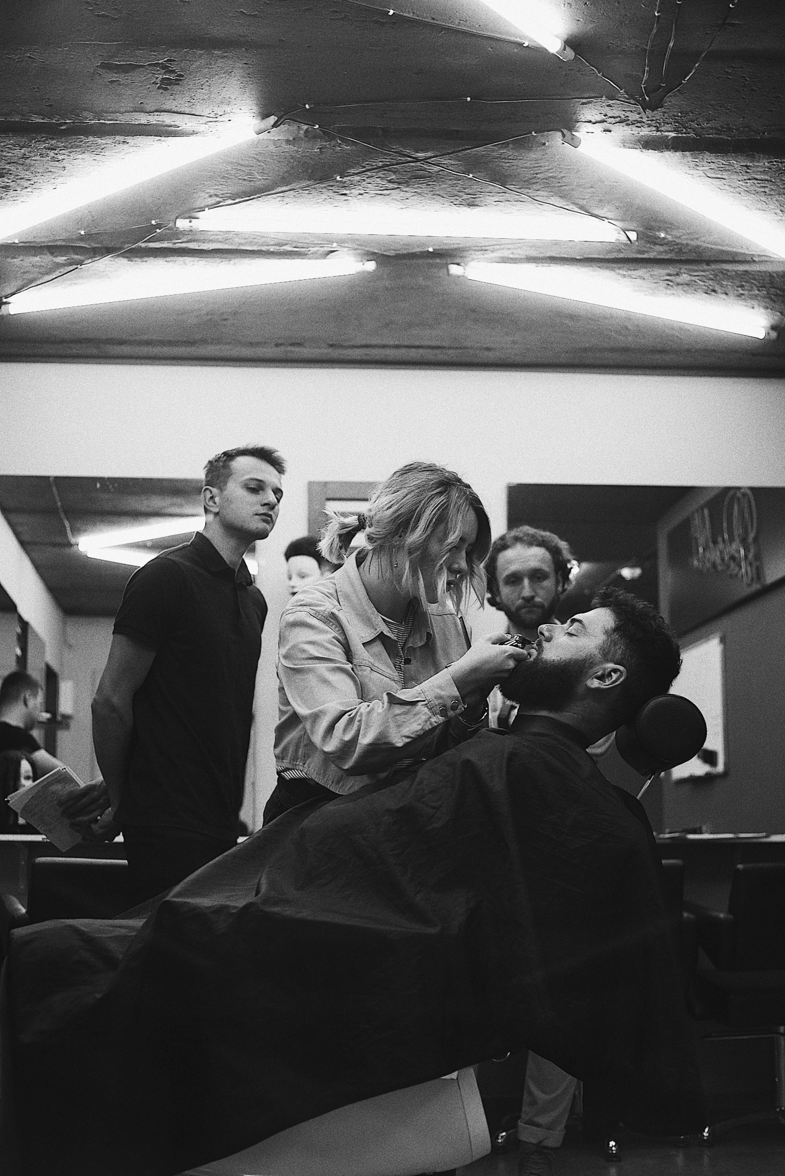 a black and white photo of a man getting his hair cut, reddit, lipstick, loish and ross tran, pierre pellegrini and ash thorp, lachlan bailey