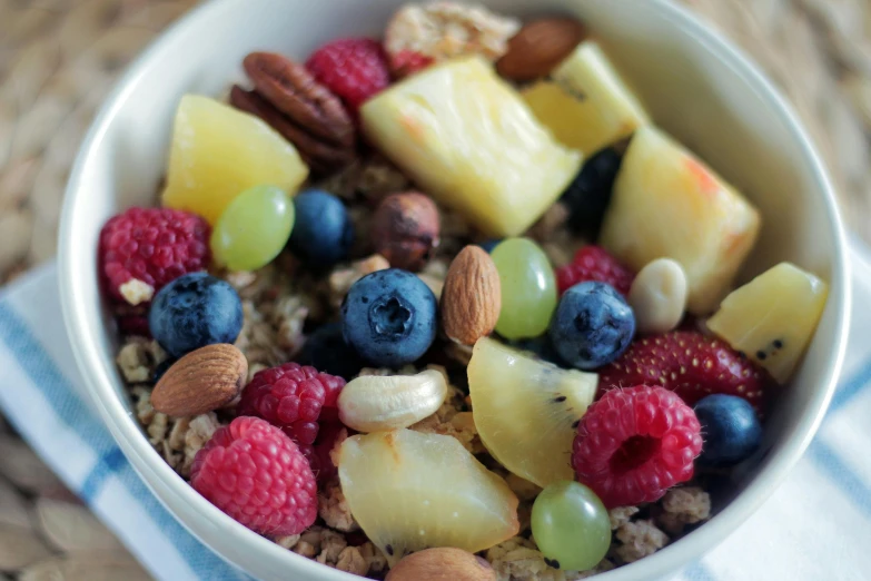 a bowl filled with fruit and nuts on top of a table, pexels, 🎀 🗡 🍓 🧚, in the morning, high angle close up shot, made of food