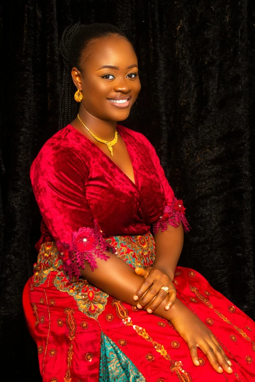 a woman in a red dress posing for a picture, by Chinwe Chukwuogo-Roy, professional photo-n 3, ornately dressed, ( ( dark skin ) ), nuri iyem