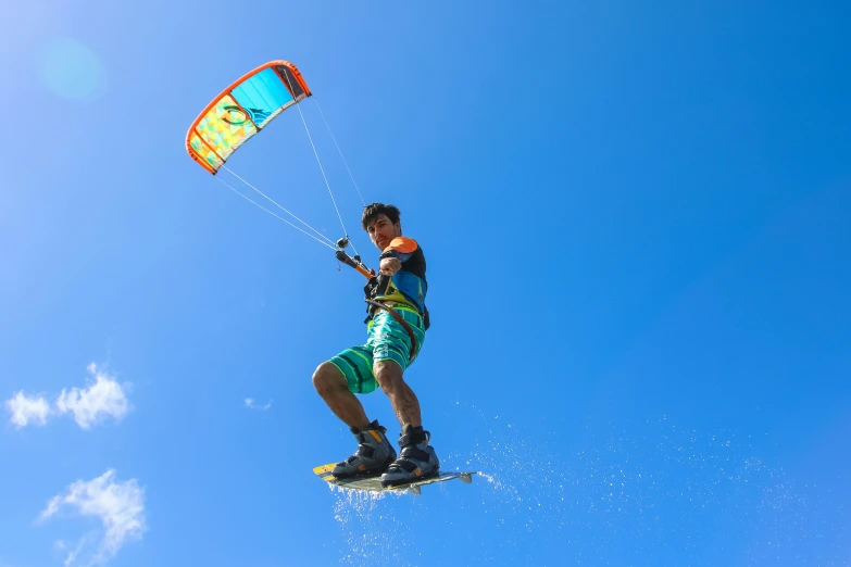 a man flying through the air while riding a kite, surfing, clear blue skies, avatar image, alexandre bourlet