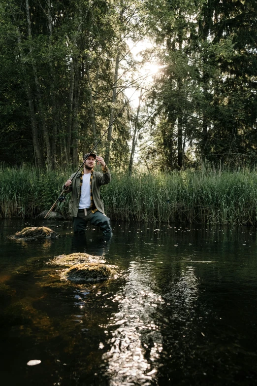 a man sitting on a rock in the middle of a river, an album cover, by Sebastian Spreng, unsplash, renaissance, trout in pants, standing in tall grass, german forest, pond