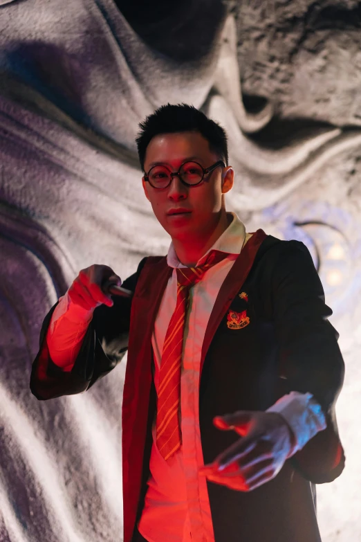 a man in a suit and tie giving a speech, an album cover, inspired by Feng Zhu, pexels contest winner, wizard casting a spell, hogwarts 2 0 7 7, asian male, hero pose