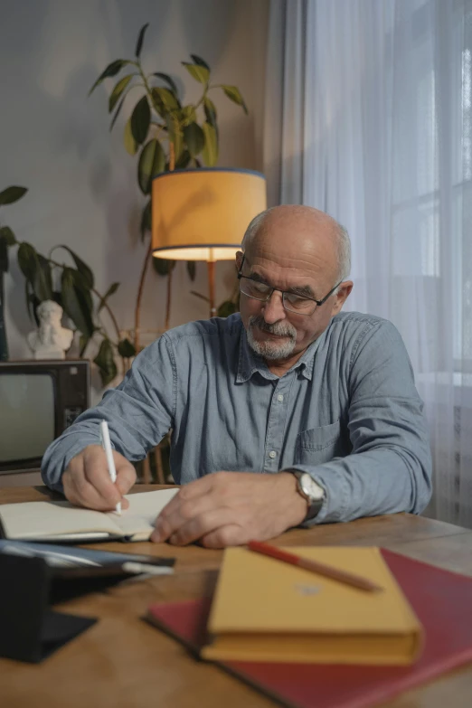 a man sitting at a table writing on a piece of paper, arbeitsrat für kunst, tv commercial, mike ehrmantraut, instagram story, profile image
