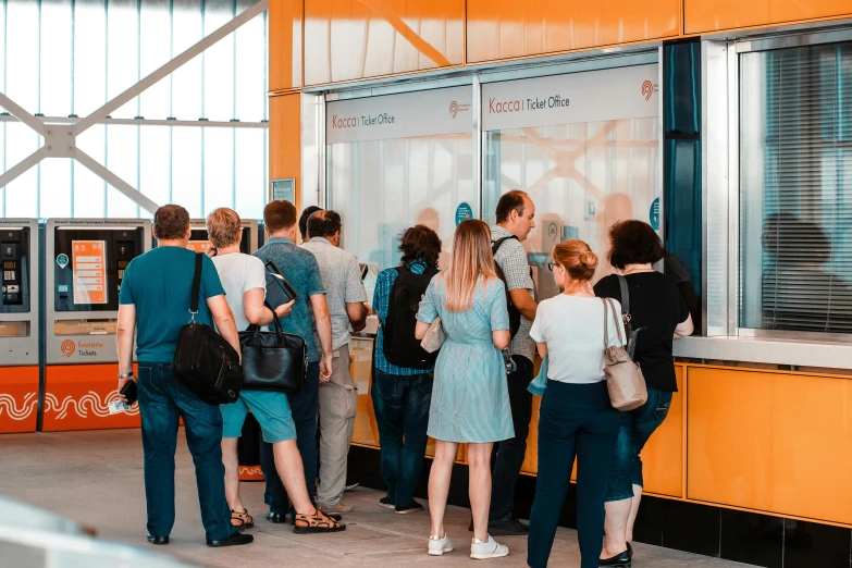 a group of people standing in front of a vending machine, by Adam Marczyński, pexels contest winner, private press, orange line, giant crypto vault, at the counter, summer season