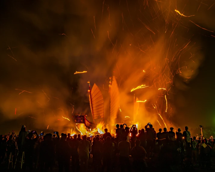 a large group of people standing around a bonfire, by Daniel Lieske, pexels contest winner, conceptual art, photograph of three ravers, pirate ships at war at night, cai guo-qiang, firework