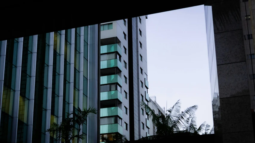 a couple of tall buildings sitting next to each other, inspired by Elsa Bleda, unsplash, brutalism, cyan shutters on windows, são paulo, hotel room, eyelevel perspective image