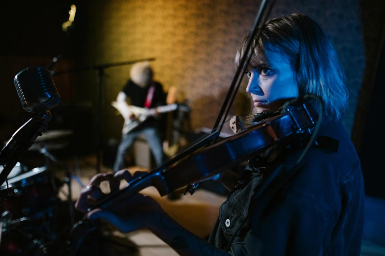 a woman playing a violin in a recording studio, pexels contest winner, realism, person in foreground, blue grass, avatar image, band