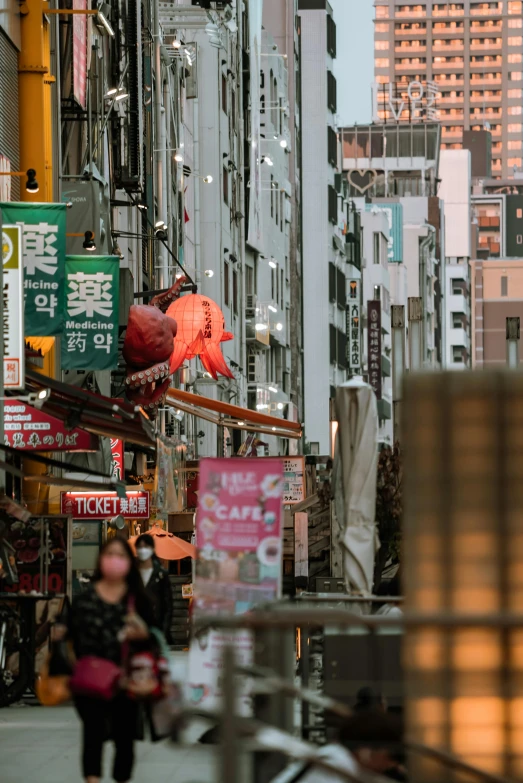 a group of people walking down a street next to tall buildings, inspired by Kanō Naizen, trending on unsplash, mingei, colorful signs, taiwan, square, ethnicity : japanese