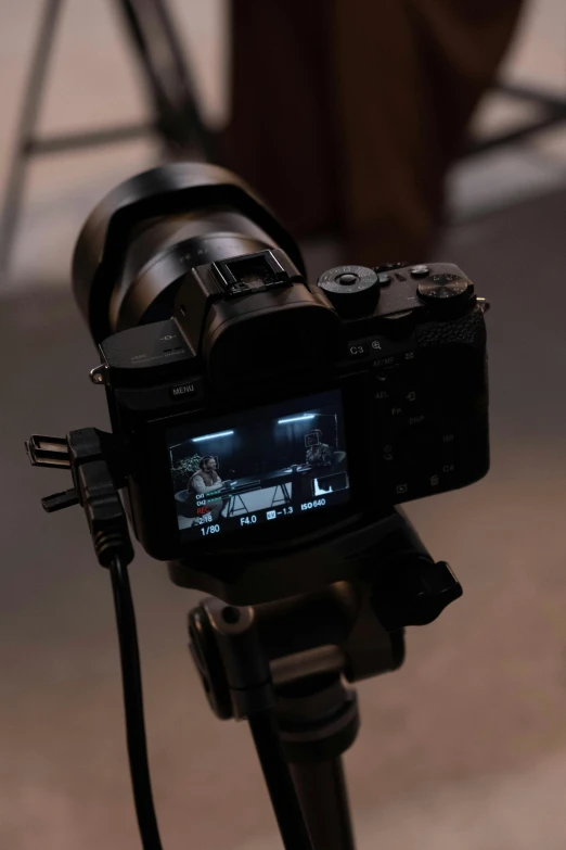 a close up of a camera on a tripod, by Glennray Tutor, video art, sony a 7 siii, indoor shot, promo image, b - roll