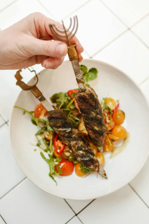 a person holding a fork over a plate of food, profile image, grilled chicken, rocket, hanging