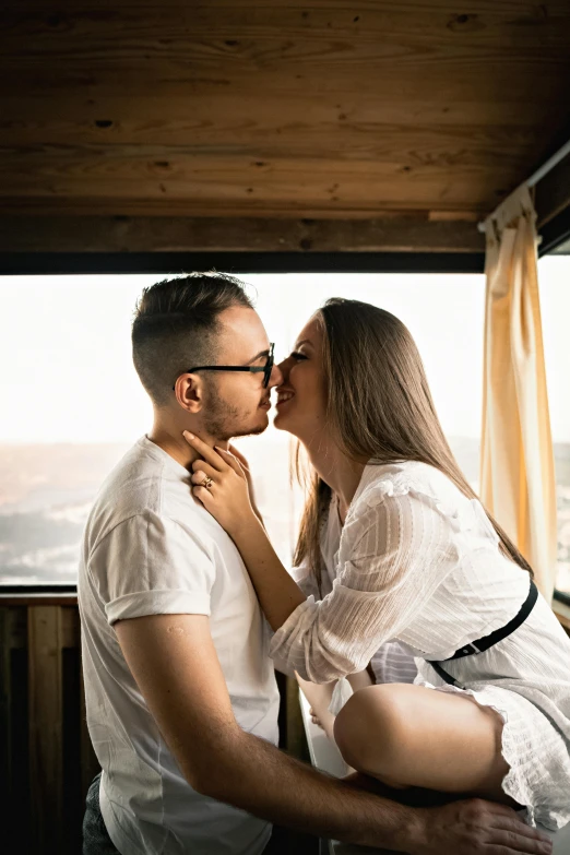 a man and a woman kissing on a balcony, trending on unsplash, in a cabin, studio photo, confident looking, video